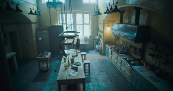 A kitchen with a table and many chairs