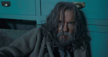 Movie still from “The Flash” (2023), directed by Andy Muschietti – A man with long grey hair and a beard; Close Up shot, Over the shoulder angle