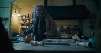 Movie still from “The Flash” (2023), directed by Andy Muschietti – An old man standing in front of a kitchen counter; Medium shot, Low angle