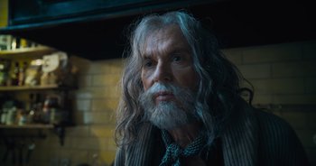 Movie still from “The Flash” (2023), directed by Andy Muschietti – An old man with long white hair and a beard; Close Up shot, Low angle