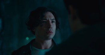 Movie still from “The Flash” (2023), directed by Andy Muschietti – A person looking at a camera; Close Up shot, Over the shoulder angle