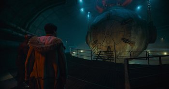 Movie still from “The Flash” (2023), directed by Andy Muschietti – A man standing in front of an underground tunnel; Extreme Wide shot, High angle