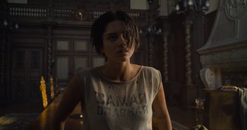 Movie still from “The Flash” (2023), directed by Andy Muschietti – A woman in a tan shirt is standing in a room; Medium shot, Low angle