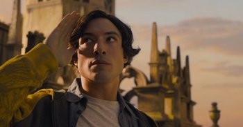 Movie still from “The Flash” (2023), directed by Andy Muschietti – A young man is saluting in front of a graveyard; Close Up shot, Low angle