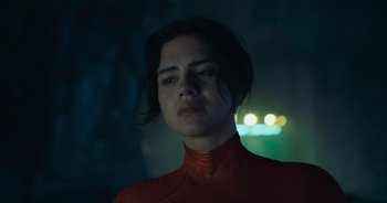 Movie still from “The Flash” (2023), directed by Andy Muschietti – A woman in a red outfit is looking at the camera; Close Up shot, Low angle