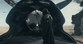 Movie still from “The Flash” (2023), directed by Andy Muschietti – A man standing in front of an alien ship; Wide shot, High angle