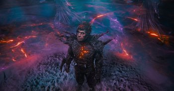 Movie still from “The Flash” (2023), directed by Andy Muschietti – An image of a man that is standing in the water; Wide shot, High angle