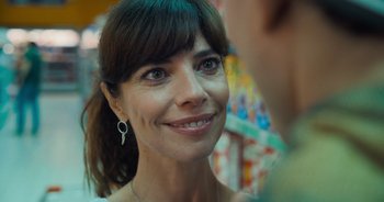 Movie still from “The Flash” (2023), directed by Andy Muschietti – A person smiling at the camera; Close Up shot, Over the shoulder angle