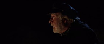 Movie still from “The Fog” (1980), directed by John Carpenter – An older man wearing a black hat looking off into the distance; Close Up shot, Low angle