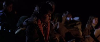 Movie still from “The Fog” (1980), directed by John Carpenter – A young boy is standing in a dark room; Close Up shot, Over the shoulder angle