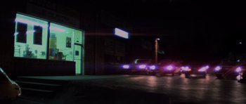 Movie still from “The Fog” (1980), directed by John Carpenter – A car parked on the side of the road at night; Extreme Wide shot, Low angle