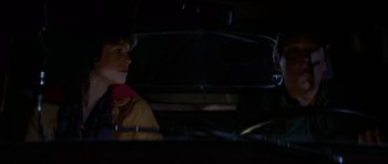 Movie still from “The Fog” (1980), directed by John Carpenter – A man and a woman sitting in the back of a car; Close Up shot, Over the shoulder angle