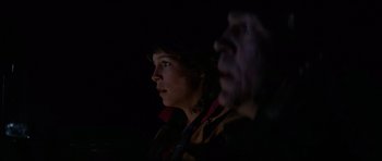 Movie still from “The Fog” (1980), directed by John Carpenter – A woman standing next to a man in a dark room; Close Up shot, Low angle