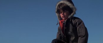 Movie still from “The Fog” (1980), directed by John Carpenter – A young child wearing a jacket and a hood; Close Up shot, Low angle