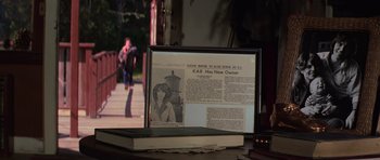 Movie still from “The Fog” (1980), directed by John Carpenter – An old newspaper sitting on top of an open book on a table; Extreme Close Up shot, High angle