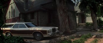 Movie still from “The Fog” (1980), directed by John Carpenter – An old car parked in front of a house; Extreme Wide shot, Low angle
