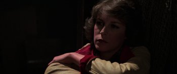 Movie still from “The Fog” (1980), directed by John Carpenter – A woman sitting in a chair with her arm around her shoulder; Close Up shot, Over the shoulder angle