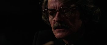 Movie still from “The Fog” (1980), directed by John Carpenter – An older man with a mustache and glasses; Close Up shot, Low angle
