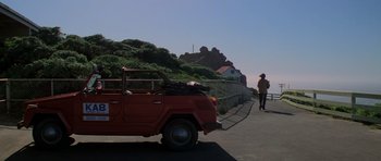 Movie still from “The Fog” (1980), directed by John Carpenter – An old red truck parked on the side of the road; Wide shot, Low angle