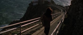 Movie still from “The Fog” (1980), directed by John Carpenter – A woman walking down a set of stairs near the ocean; Extreme Wide shot, High angle