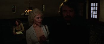 Movie still from “The Fog” (1980), directed by John Carpenter – An older woman standing next to an older man; Close Up shot, Over the shoulder angle