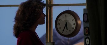 Movie still from “The Fog” (1980), directed by John Carpenter – A woman is looking at a clock in a window; Close Up shot, Low angle