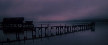 Movie still from “The Fog” (1980), directed by John Carpenter – A pier that is in the middle of the water; Extreme Wide shot, Low angle