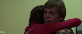 Movie still from “The Fog” (1980), directed by John Carpenter – A man holding a woman in his arms; Close Up shot, Over the shoulder angle