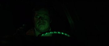 Movie still from “The Fog” (1980), directed by John Carpenter – A man in a car at night with green lights; Close Up shot, High angle