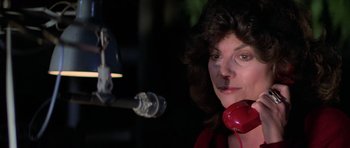 Movie still from “The Fog” (1980), directed by John Carpenter – A woman is holding a red phone up to her ear; Close Up shot, Low angle