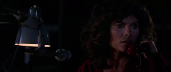 Movie still from “The Fog” (1980), directed by John Carpenter – A person wearing a red shirt; Close Up shot, Over the shoulder angle