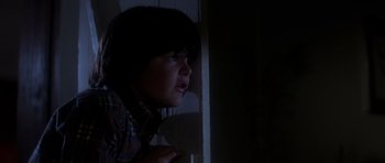Movie still from “The Fog” (1980), directed by John Carpenter – A young boy looking out of a window at night; Close Up shot, Low angle