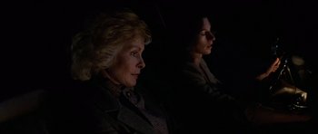 Movie still from “The Fog” (1980), directed by John Carpenter – Two women sitting side by side in the dark; Close Up shot, Low angle