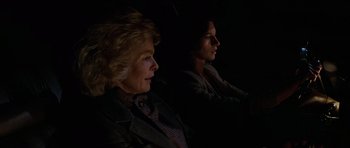 Movie still from “The Fog” (1980), directed by John Carpenter – Two women sitting side by side in the dark; Close Up shot, Over the shoulder angle