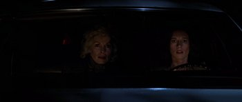 Movie still from “The Fog” (1980), directed by John Carpenter – A woman looking out of the window of a car at night; Close Up shot, Low angle