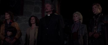 Movie still from “The Fog” (1980), directed by John Carpenter – Three people standing next to each other in the dark; Medium shot, Low angle