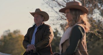 Movie still from “The Forever Purge” (2021), directed by Everardo Gout – A man and a woman wearing cowboy hats; Medium shot, Over the shoulder angle