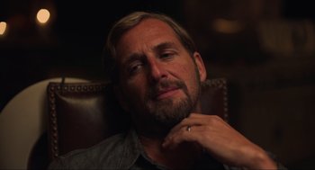 Movie still from “The Forever Purge” (2021), directed by Everardo Gout – A person sitting in a chair with his hand under his chin; Close Up shot, Over the shoulder angle