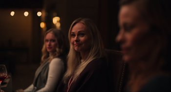 Movie still from “The Forever Purge” (2021), directed by Everardo Gout – A group of women sitting next to each other in a room; Close Up shot, Over the shoulder angle