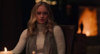 Movie still from “The Forever Purge” (2021), directed by Everardo Gout – A woman sitting in a chair looking down at the floor; Close Up shot, Over the shoulder angle
