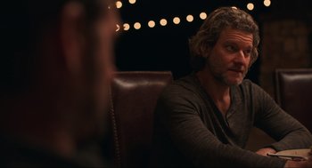 Movie still from “The Forever Purge” (2021), directed by Everardo Gout – A man with long hair sitting in front of another man; Close Up shot, Over the shoulder angle