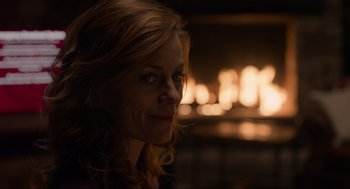 Movie still from “The Forever Purge” (2021), directed by Everardo Gout – A person in front of a fireplace; Close Up shot, Over the shoulder angle