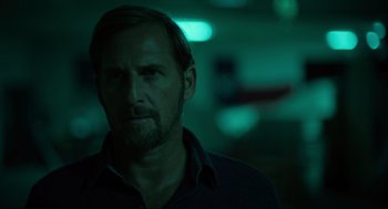 Movie still from “The Forever Purge” (2021), directed by Everardo Gout – A person wearing a black shirt; Close Up shot, Over the shoulder angle