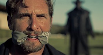 Movie still from “The Forever Purge” (2021), directed by Everardo Gout – A person with duct tape on his mouth; Close Up shot, Low angle