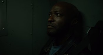 Movie still from “The Forever Purge” (2021), directed by Everardo Gout – A man with a beard is looking up at the sky; Close Up shot, Low angle