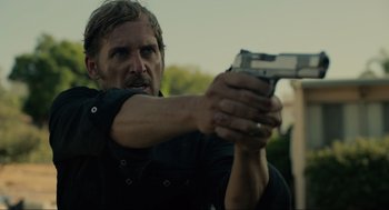 Movie still from “The Forever Purge” (2021), directed by Everardo Gout – A man holding a gun in his hand; Close Up shot, Over the shoulder angle