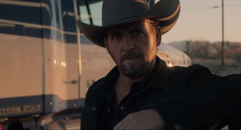 Movie still from “The Forever Purge” (2021), directed by Everardo Gout – A man in a cowboy hat is posing for a picture; Close Up shot, Over the shoulder angle