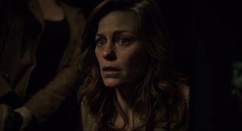 Movie still from “The Forever Purge” (2021), directed by Everardo Gout – A person with long brown hair; Close Up shot, Over the shoulder angle