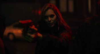 Movie still from “The Forever Purge” (2021), directed by Everardo Gout – A woman is holding a gun in a dark room; Close Up shot, Low angle