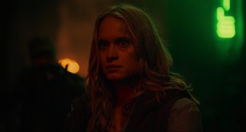 Movie still from “The Forever Purge” (2021), directed by Everardo Gout – A man with long blonde hair is staring at the camera; Close Up shot, Over the shoulder angle